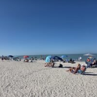 CREW SWFL Beach Cleanup Day - CREW members on the beach cleaning up