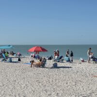 CREW SWFL Beach Cleanup Day - CREW members on the beach cleaning up