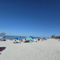 CREW SWFL Beach Cleanup Day - CREW members on the beach cleaning up